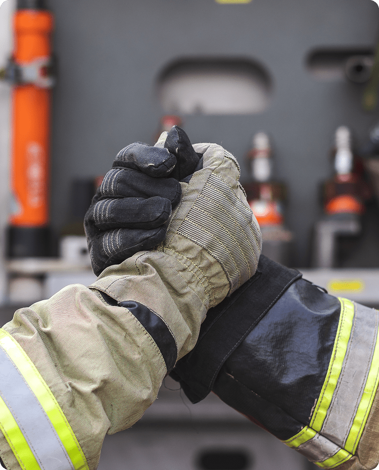 Firefighters shaking hands wearing protective gear.