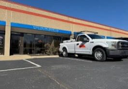 Truck parked outside a commercial building.
