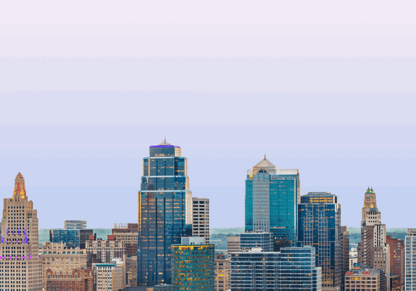 City skyline with modern high-rise buildings under a clear sky.